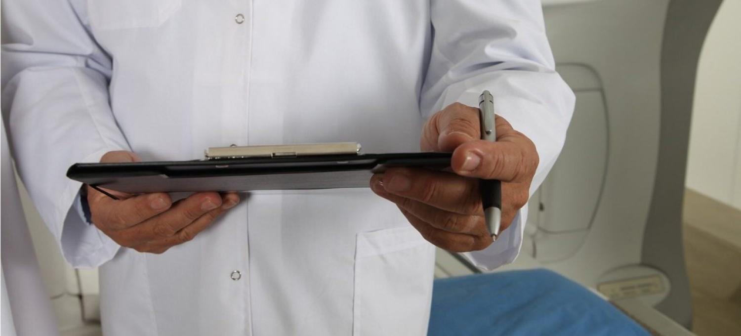 A doctor holding a clipboard